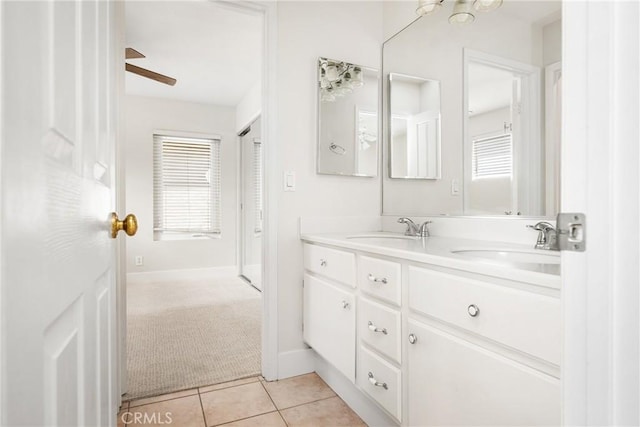 bathroom featuring plenty of natural light, double vanity, a sink, and tile patterned floors