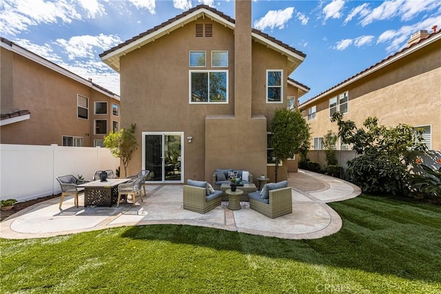 back of property with a lawn, fence, a patio, and stucco siding