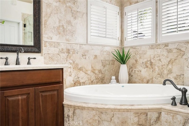 bathroom featuring vanity and a bath