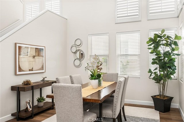 dining space with wood finished floors and baseboards