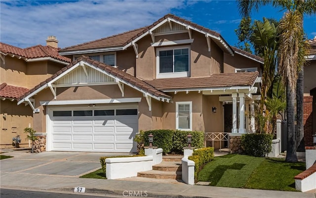 view of front of property featuring a tile roof, driveway, an attached garage, and stucco siding