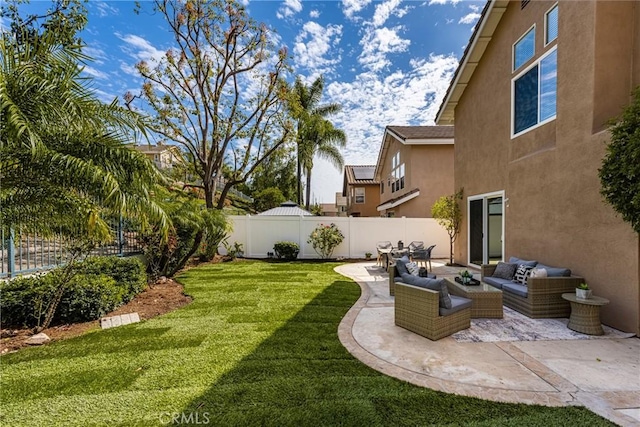 view of yard with a patio area, a fenced backyard, and an outdoor living space