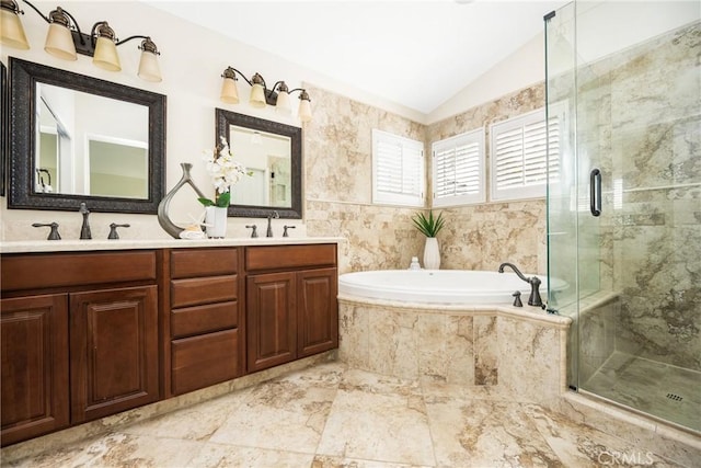 full bath with lofted ceiling, a stall shower, a sink, and a garden tub