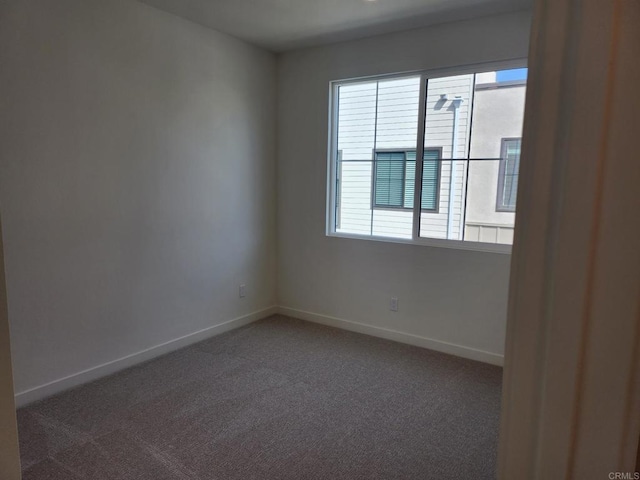 carpeted spare room featuring a healthy amount of sunlight