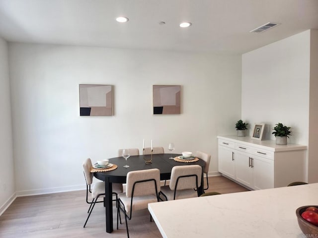 dining space with light hardwood / wood-style floors