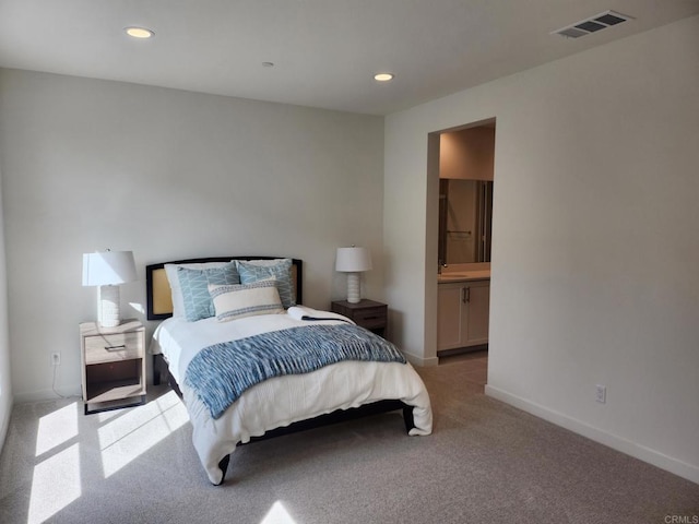 carpeted bedroom with ensuite bath