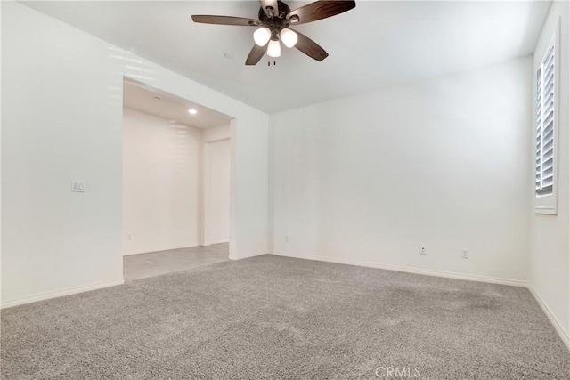 spare room featuring ceiling fan and carpet flooring