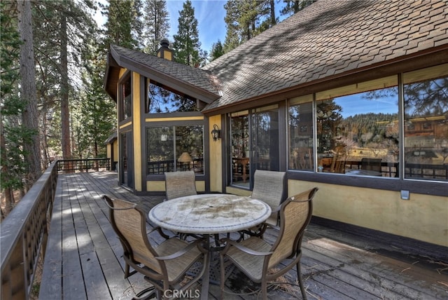 wooden deck featuring outdoor dining area