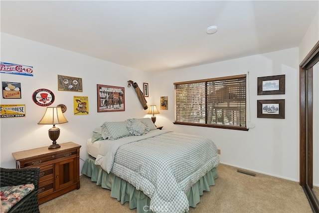 bedroom with visible vents and light colored carpet