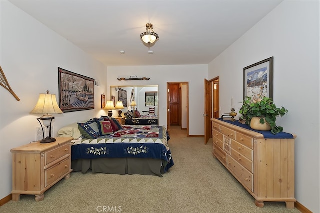 bedroom featuring baseboards and light carpet