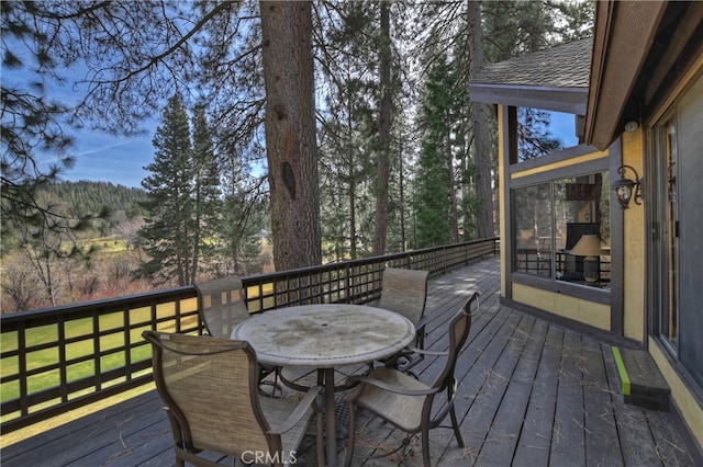 deck featuring outdoor dining area