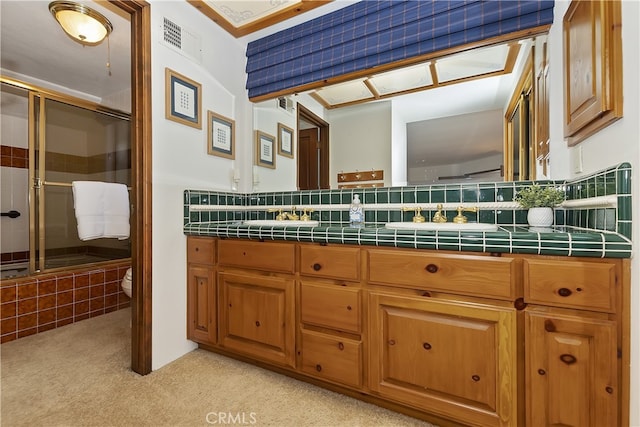 bathroom with visible vents, an enclosed shower, toilet, and double vanity