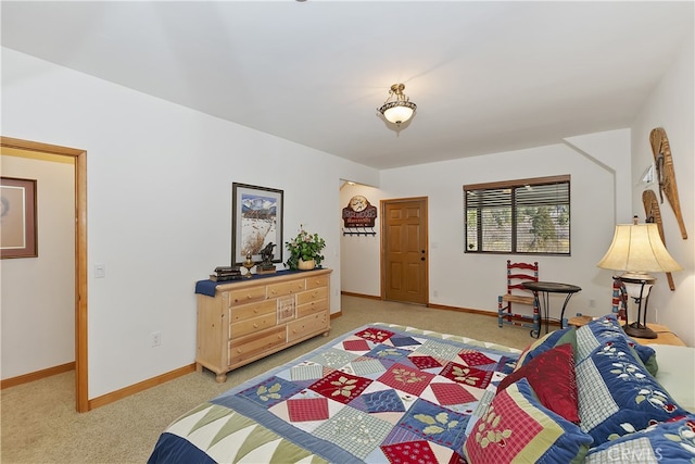 bedroom with baseboards and carpet