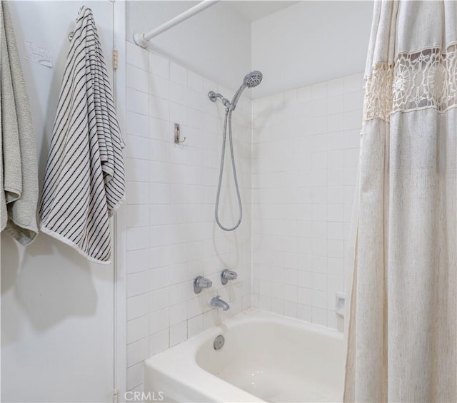 bathroom with shower / bath combo with shower curtain