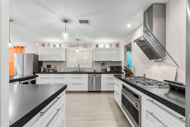 kitchen featuring white cabinetry, dark countertops, stainless steel appliances, and open shelves