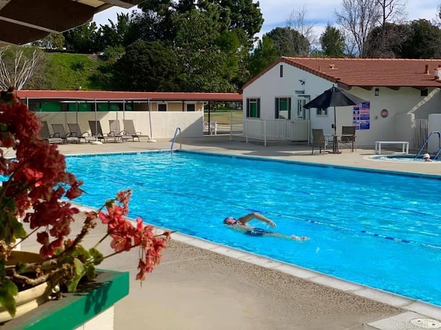 view of swimming pool featuring a patio area