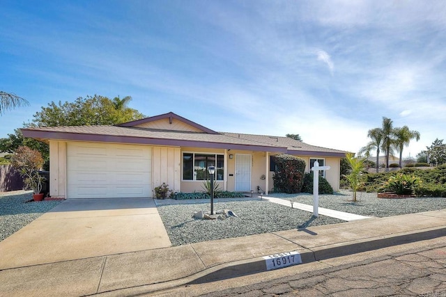 ranch-style house with an attached garage and concrete driveway