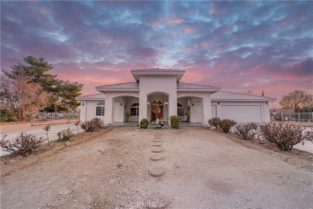 mediterranean / spanish home with a garage