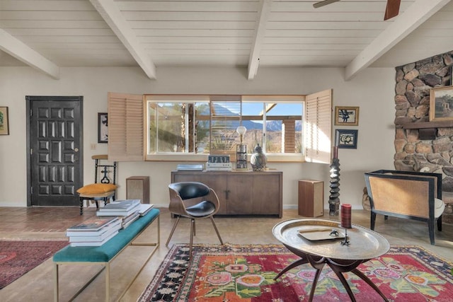 interior space with ceiling fan and beamed ceiling