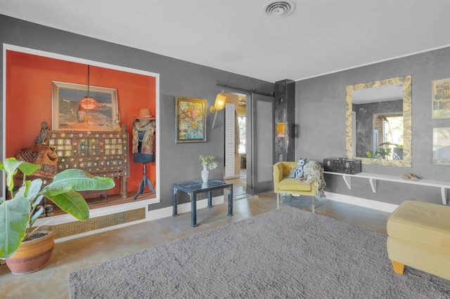 sitting room featuring concrete flooring