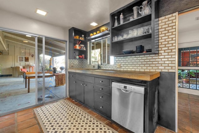 bar featuring sink, dishwasher, butcher block countertops, and decorative backsplash