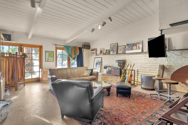 living room featuring concrete flooring, brick wall, wooden ceiling, beamed ceiling, and rail lighting