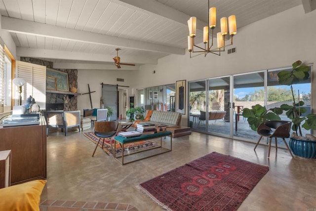 living room featuring ceiling fan with notable chandelier, beamed ceiling, and concrete floors