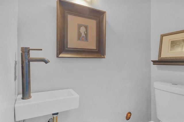 bathroom featuring sink and toilet