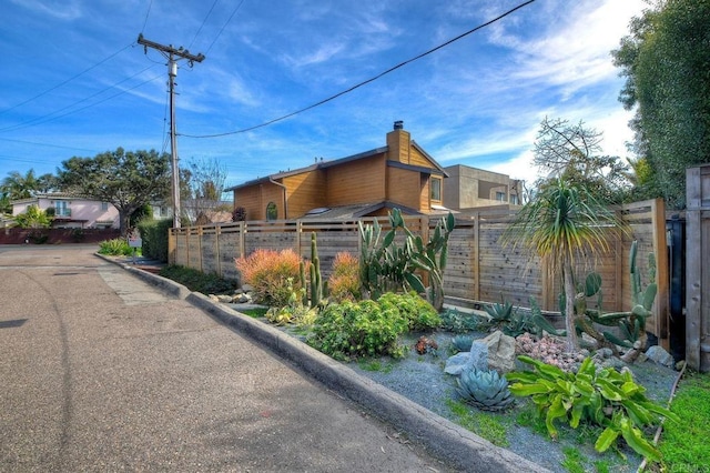 view of side of home featuring fence