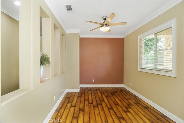 spare room with dark hardwood / wood-style flooring, ornamental molding, and ceiling fan