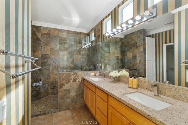 bathroom featuring a tile shower, vanity, tile patterned flooring, and crown molding