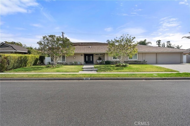 single story home featuring a front yard and a garage