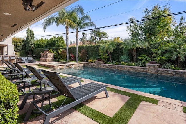 view of pool with a patio, a fenced backyard, an in ground hot tub, an outdoor stone fireplace, and a fenced in pool