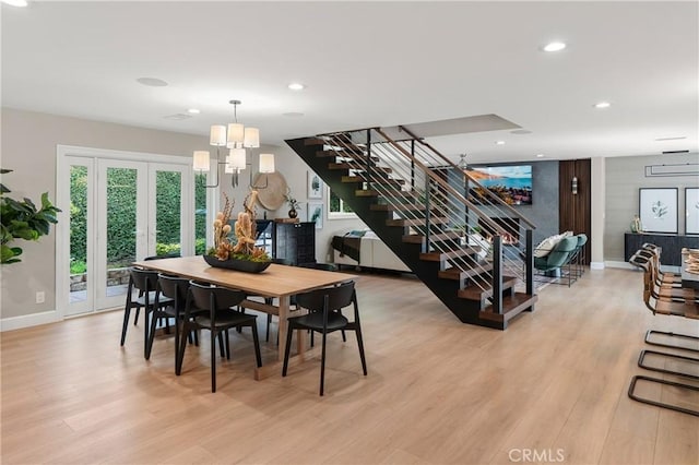 dining room featuring light wood-style floors, recessed lighting, and stairs