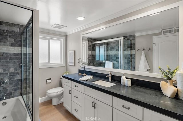 full bathroom with visible vents, toilet, ornamental molding, wood finished floors, and vanity