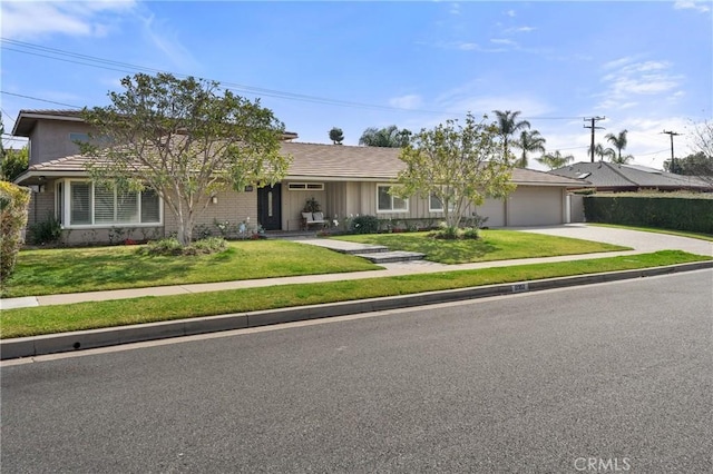 ranch-style house featuring driveway, a garage, and a front yard