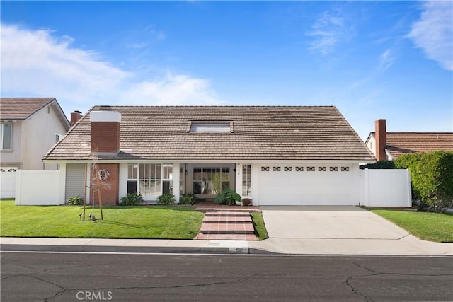 view of front of property with a front yard and a garage