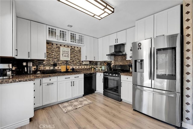 kitchen with wall chimney range hood, gas range, white cabinets, stainless steel fridge with ice dispenser, and dishwasher