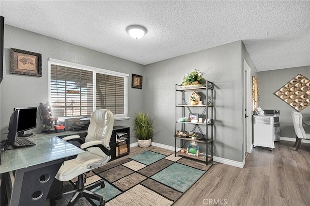 office space with baseboards, dark wood-style floors, and a textured ceiling