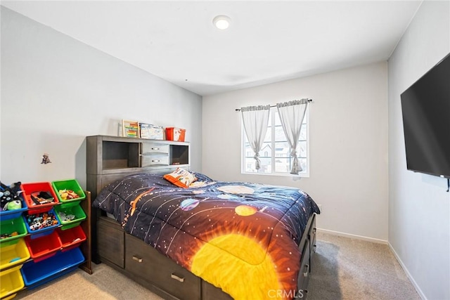 carpeted bedroom featuring baseboards