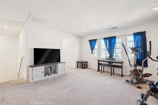 exercise area with visible vents, carpet floors, and baseboards