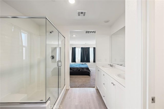 full bathroom with ensuite bath, wood finished floors, visible vents, and a stall shower