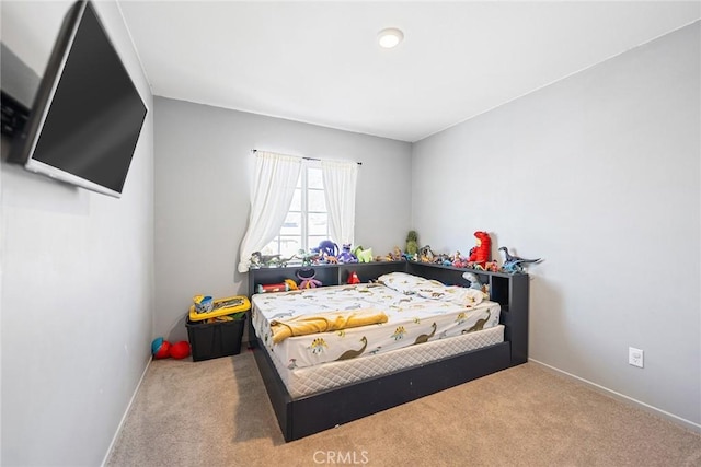 bedroom featuring baseboards and carpet floors