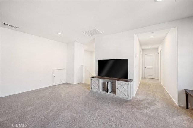unfurnished living room featuring visible vents, baseboards, and carpet flooring