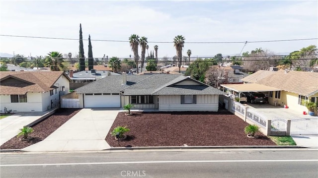 single story home with an attached garage, fence, a residential view, concrete driveway, and a shingled roof