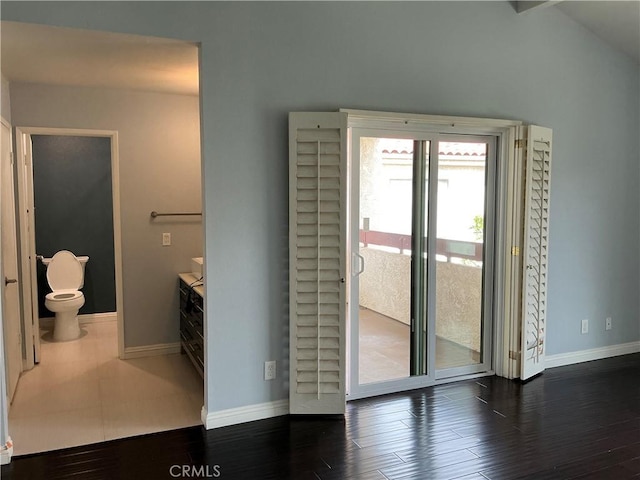 interior space featuring baseboards and wood finished floors