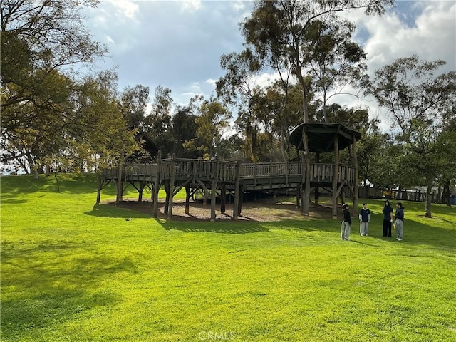 surrounding community featuring a lawn and a wooden deck