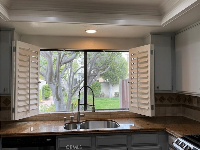 kitchen with tasteful backsplash, plenty of natural light, dishwasher, and a sink