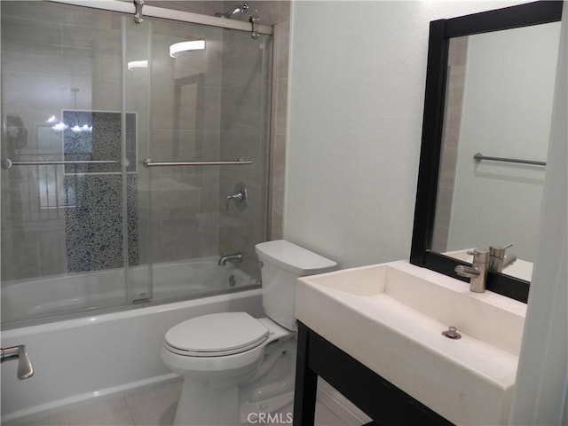 bathroom featuring vanity, toilet, tile patterned flooring, and shower / bath combination with glass door