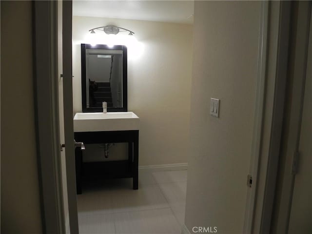 bathroom featuring tile patterned floors, vanity, and baseboards